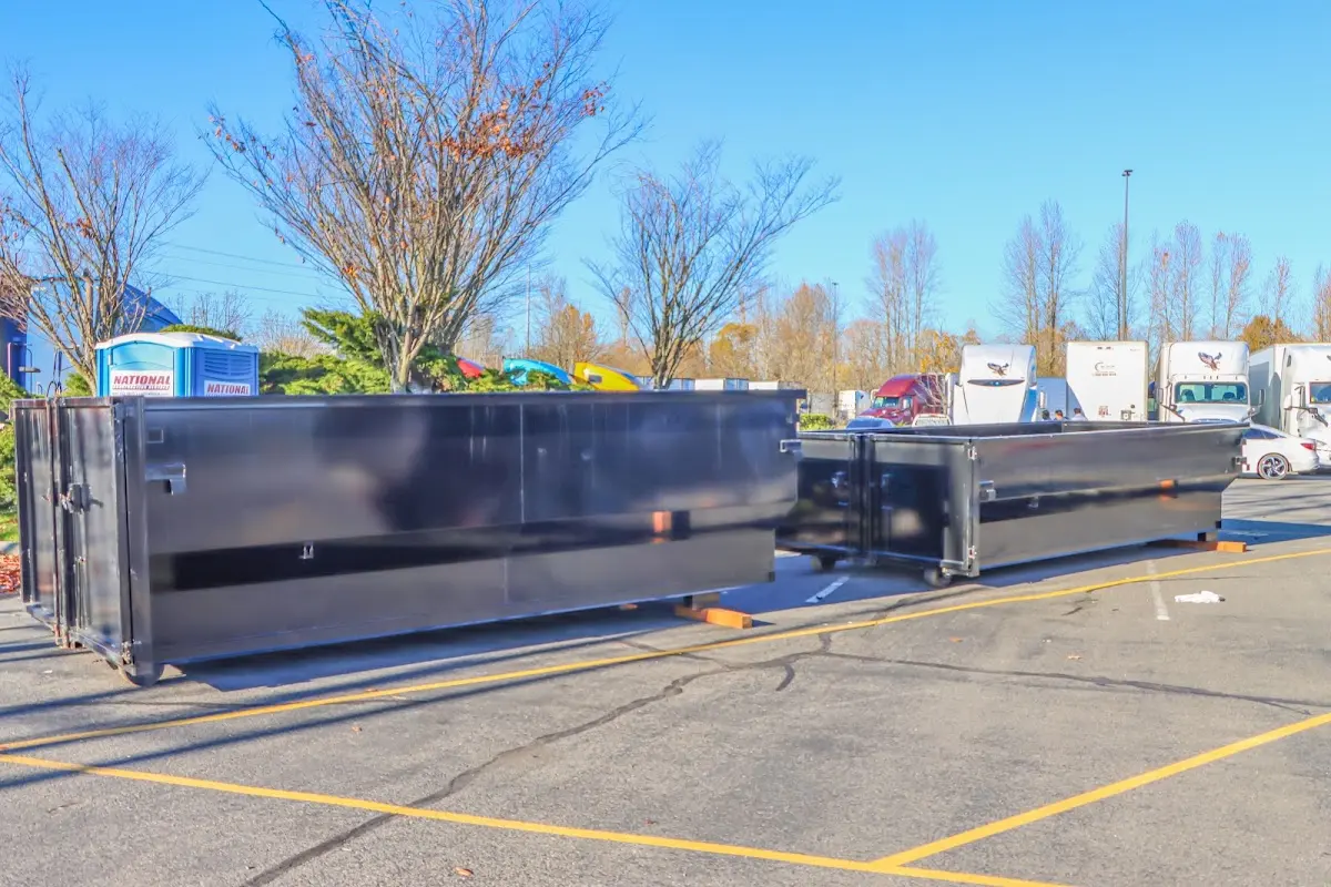 Professional dumpster rental service with roll-off container on residential driveway in Gentry